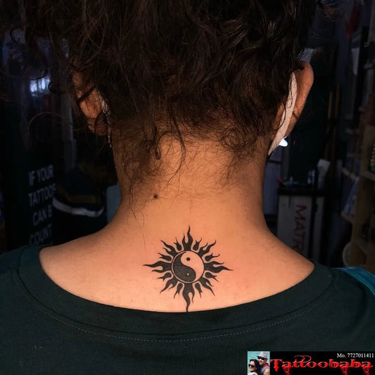 Small Blackwork Yin Yang Sun Tattoo on Women Neck by @tattoobaba_jaipur