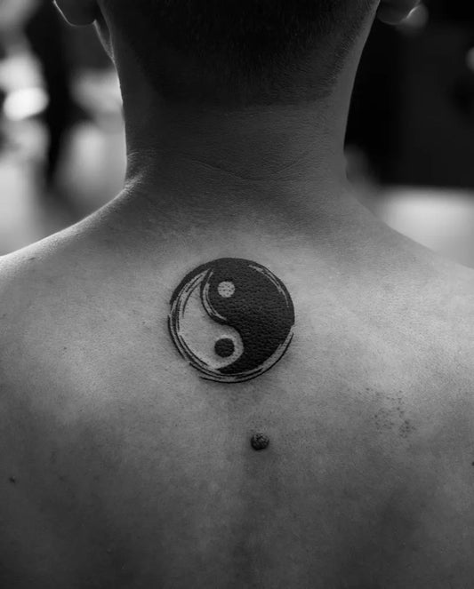 Small Blackwork Yin Yang Tattoo on Men Back by @ilu.artwork