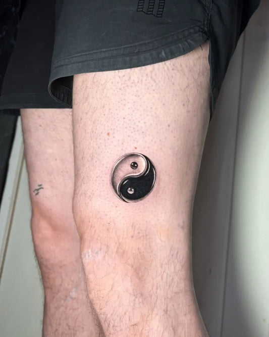 Small Blackwork Yin Yang Tattoo on Men Knee by @lil.kim_tattoo
