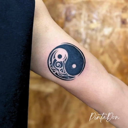 Small Blackwork Yin Yang Tattoo on Women Arm by @pintadon_tattoo