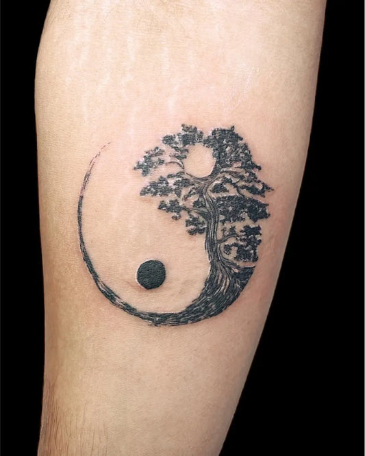 Small Blackwork Yin Yang Tree Tattoo on Men Forearm by @tattoos11.in
