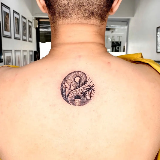 Small Blackwork Yin Yang with Mountains and Palm Trees Tattoo on Men Back by @joshuabacolod.