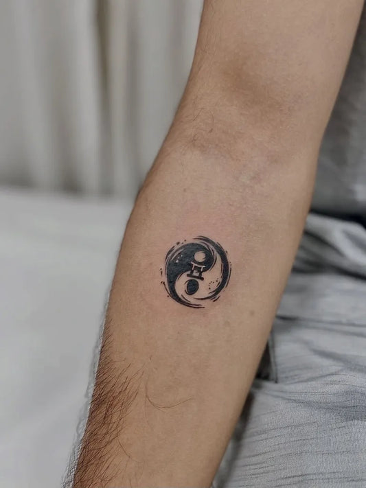 Small Blackwork YinYang Tattoo on Men Arm by @tattoo_thailand