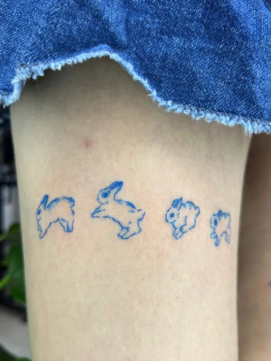 Small Blue Bunny Tattoo on Women Thigh by @bla.inkk