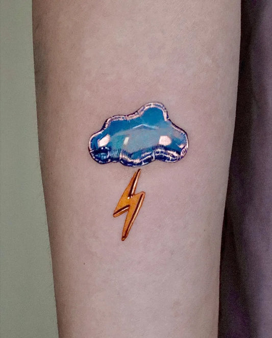 Small Blue Cloud with Lightning Tattoo on Women Arm by @tattooist_irae2