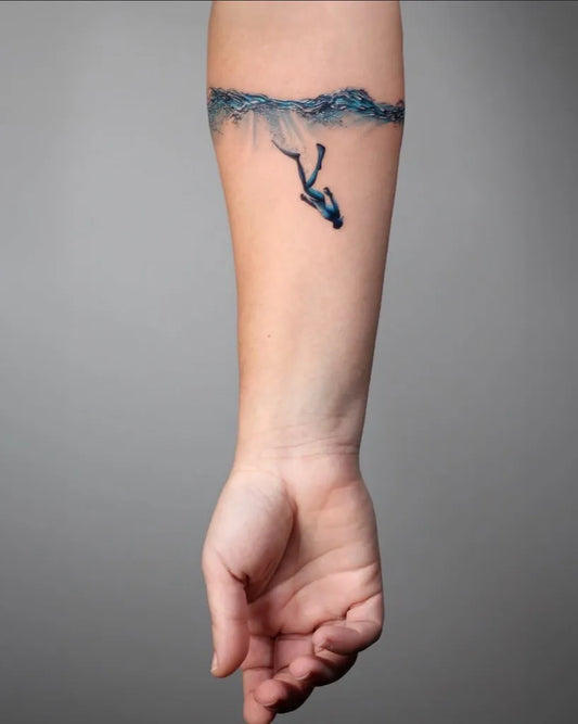 Small Blue Diver and Waves Tattoo on Women Arm by @txttooing