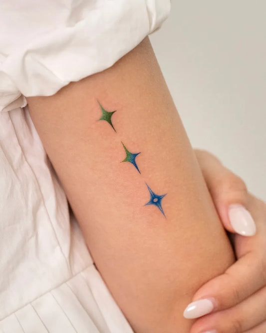 Small Blue Green Star Tattoo on Women Arm by @uni_tattoo