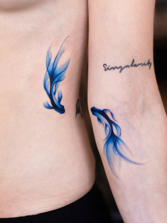 Small Blue Koi Fish Tattoo on Women Ribside by @pokhy_tattoo