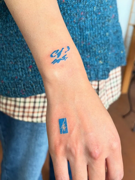 Small Blue Lightning Bolt Tattoo on Women Wrist by @ghislain______