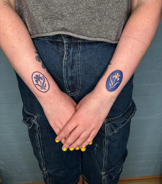 Small Blue Oval Iris Flower Tattoo on Women Wrists by @__full__house