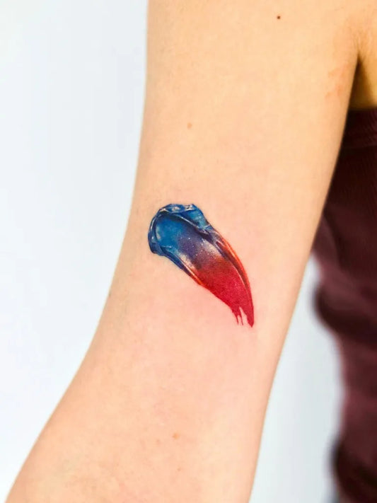 Small Blue Paint Splash Tattoo on Women Arm by @blankleaving_studio