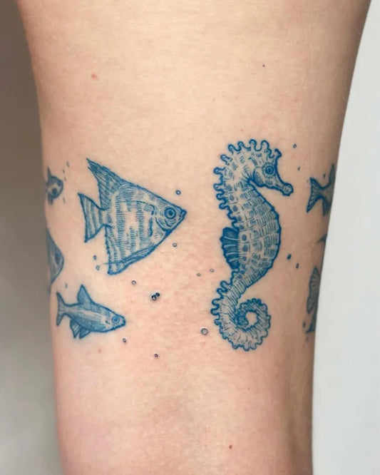 Small Blue Seahorse and Angel Fish Tattoo on Women Ankle by @pelc.tt