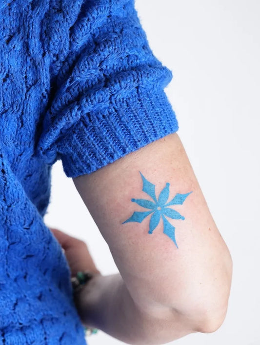 Small Blue Snowflake Tattoo on Women Arm by @occultatatt