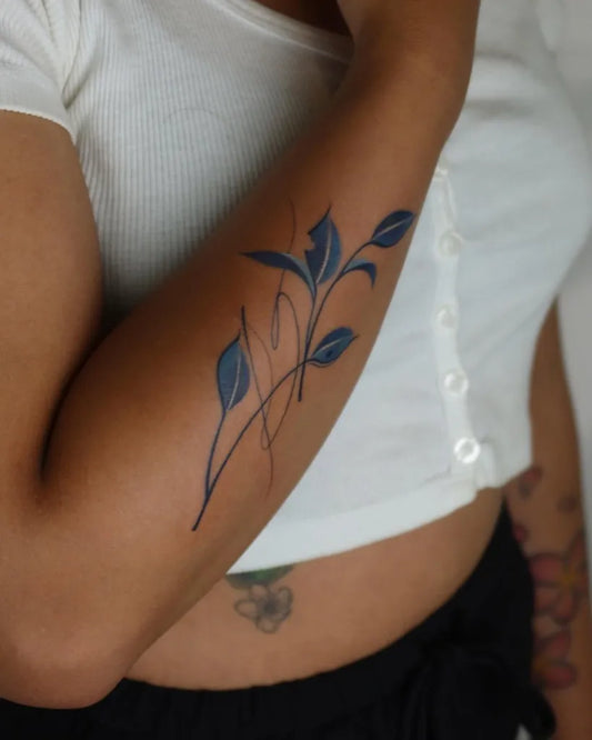 Small Blue SprigTattoo on Women Arm by @xinbi.tattoo_