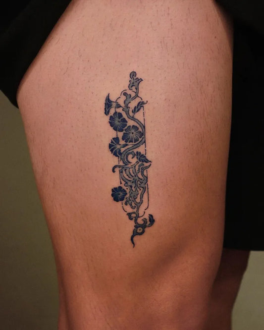 Small Blue Vine and Flowers Tattoo on Women Thigh by @wabisabi_ttt