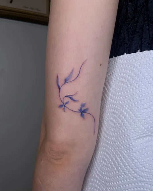 Small Blue Vines Tattoo on Women Arm by @howetattoo