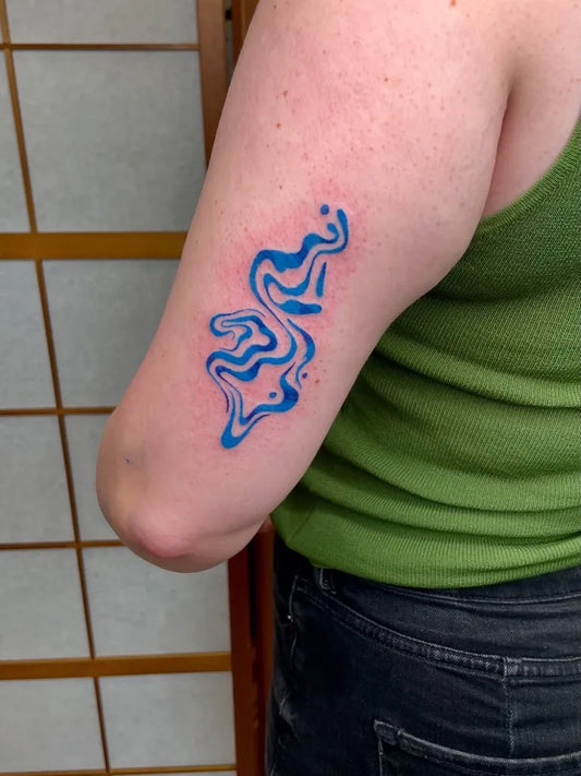 Small Blue Wavy Abstract Lines Tattoo on Women Arm by @ekellytattoos