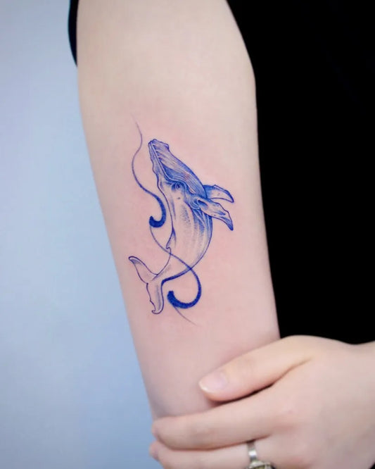 Small Blue Whale Tattoo on Women Arm by @tattooist_taker