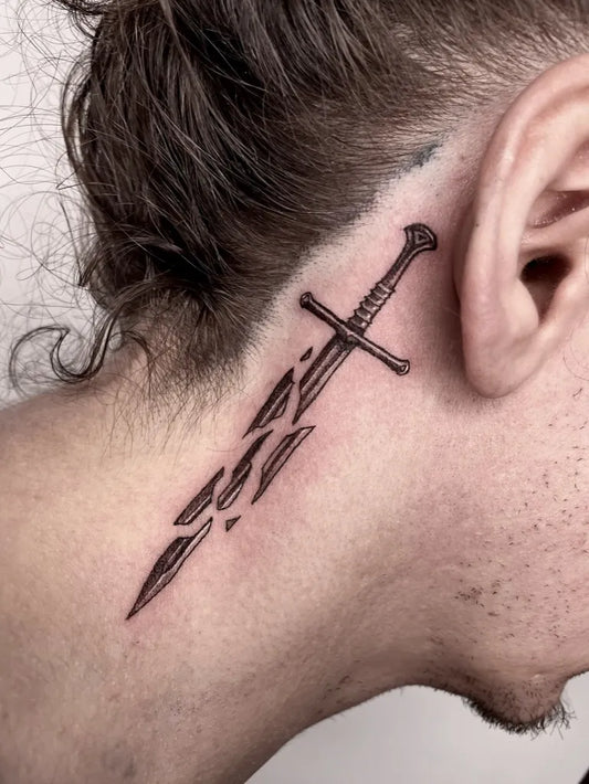 Small Broken Sword on Men Behind the Ear Tattoo by @shiivvv.tattoos