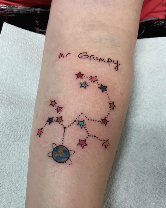 Small Cartoonish Mr Grumpy Constellation on Women Arm Tattoo by @sacred.ghost_tattoo