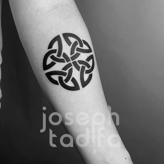 Small Celtic Knot Tattoo on Women Arm by @josephtadifa