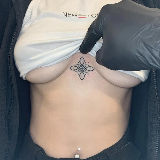 Small Celtic Knot on Women Sternum Tattoo by @gmeektattoo