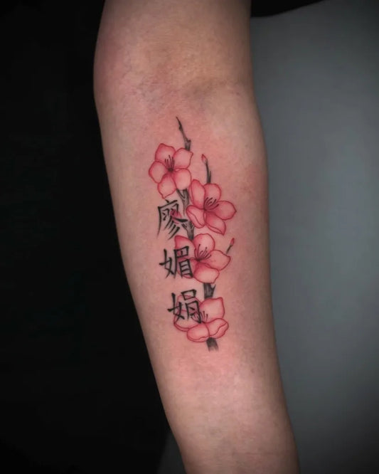 Small Chinese Cherry Blossom Branch with Name Tattoo on Women Arm by @kyle.inkz
