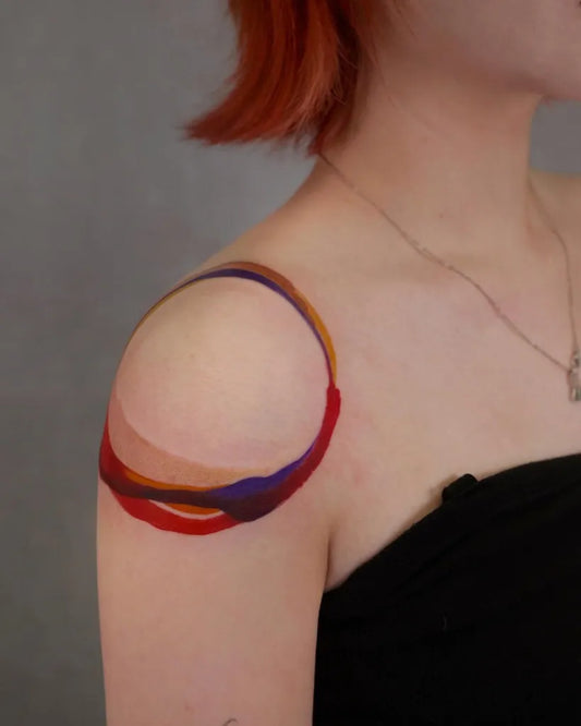 Small Color Abstract Rings Tattoo on Women Shoulder by @chenjie.newtattoo