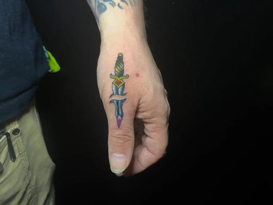Small Color Dagger Tattoo on Men Hand by @tatsby_dev