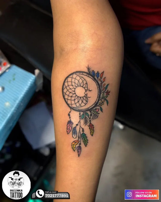 Small Color Dream Catcher with Flowers Tattoo on Women Arm by @buzzinkatattoos_mumbai
