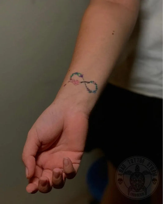 Small Color Infinity Symbol with Flowers Tattoo on Women Wrist by @kurotattoopalembang