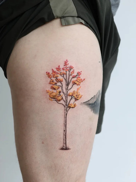 Small Color Maple Tree Tattoo on Men Thigh by @wolfdencustomtattoo