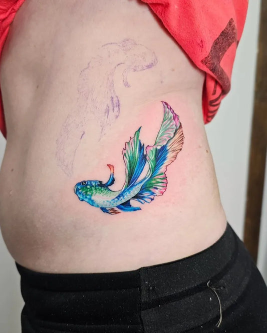Small Color Realism Betta Fish Tattoo on Women Rib by @saramachenart