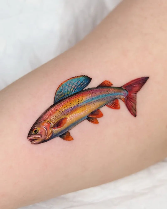 Small Color Realism Rainbow Trout Fish Tattoo on Women Forearm by @tattooist_yum