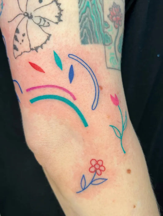 Small Colorful Butterfly Flowers Tattoo on Women Arm by @agataris