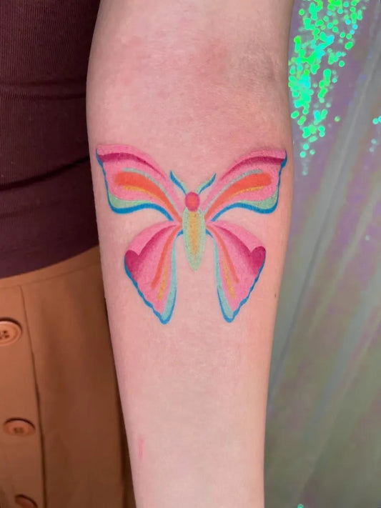 Small Colorful Butterfly Tattoo on Women Arm by @kikipokie