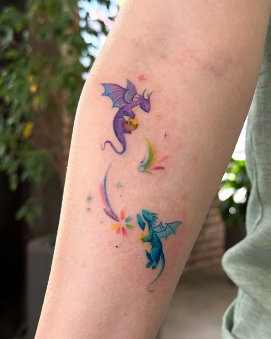 Small Colorful Dragons Tattoo on Women Arm by @ovenlee.tattoo