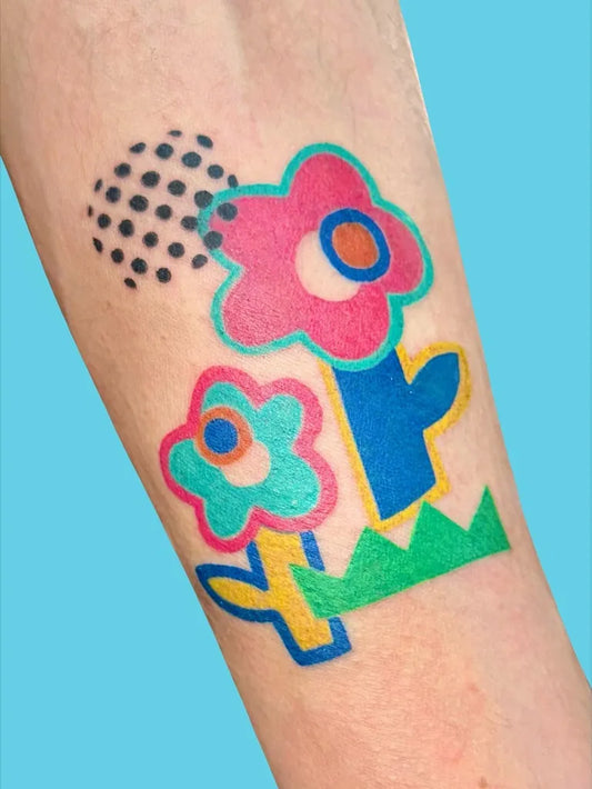 Small Colorful Flower Tattoo on Women Arm by @witaminat