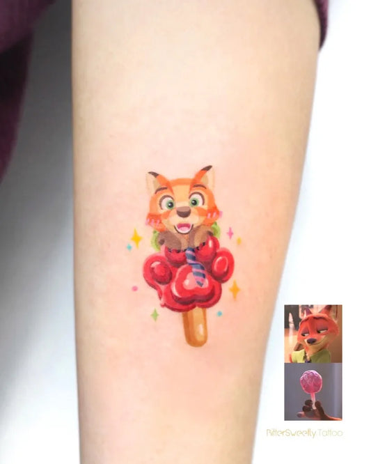Small Colorful Fox with Lollipop Tattoo on Women Arm by @bittersweetly.tattoo