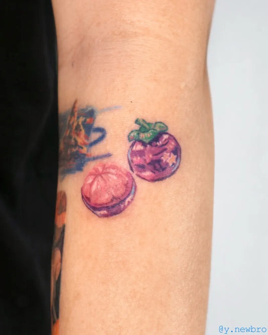Small Colorful Macaron Tomato Tattoo on Women Arm by @y.newbro