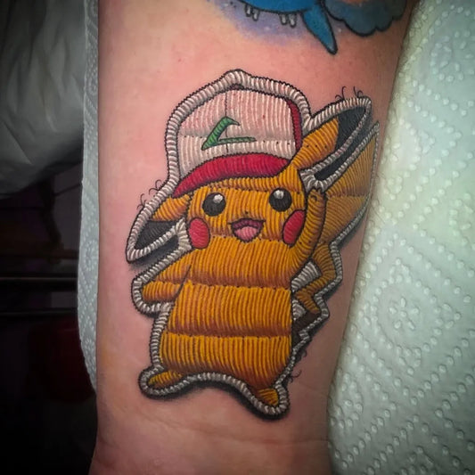 Small Colorful Pikachu Patch Tattoo on Men Arm by @ben.f.ink