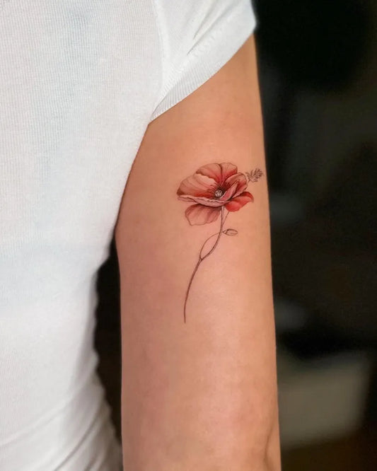 Small Colorful Poppy Flower Tattoo on Women Upper Arm by @jessee__art