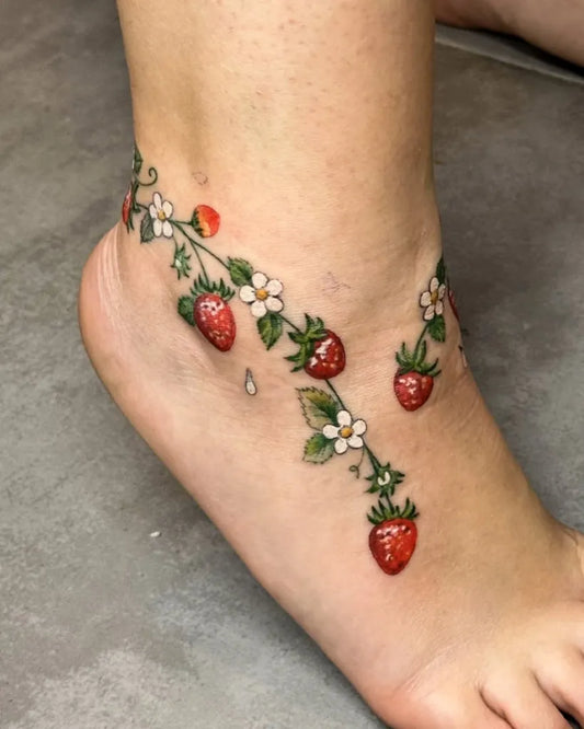 Small Colorful Strawberry Vine Tattoo on Women Ankle by @emel.tattooart
