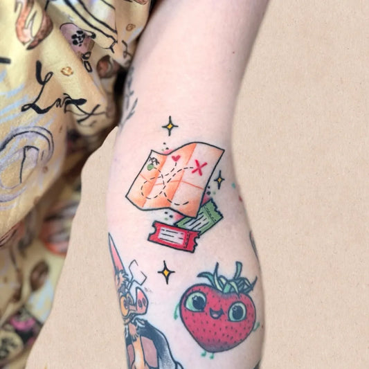 Small Colorful Treasure Map Strawberry Tattoo on Women Arm by @mstraditionaltattoo
