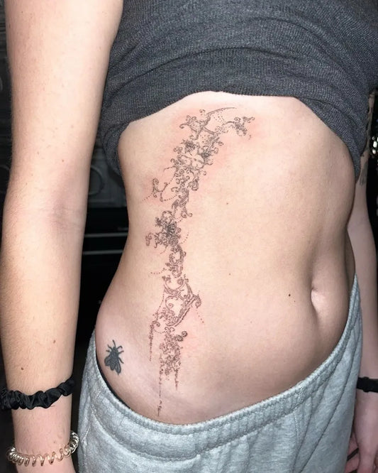 Small Cyber Sigilism Bee Branch on Women Rib Tattoo by @tattooforest_ed