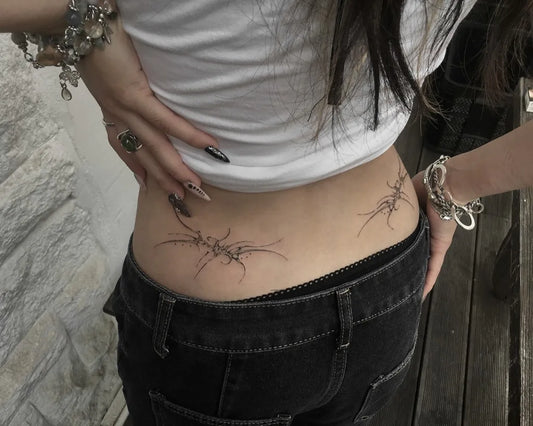 Small Cyber Sigilism on Women Back Tattoo by @keeshetattoo