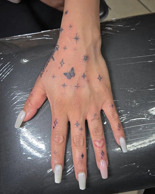 Small Delicate Stars Butterflies on Women Fingers Tattoo by @chucho8g