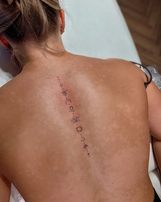 Small Delicate Symbols and Moon on Women Spine Tattoo by @tinytatswigan