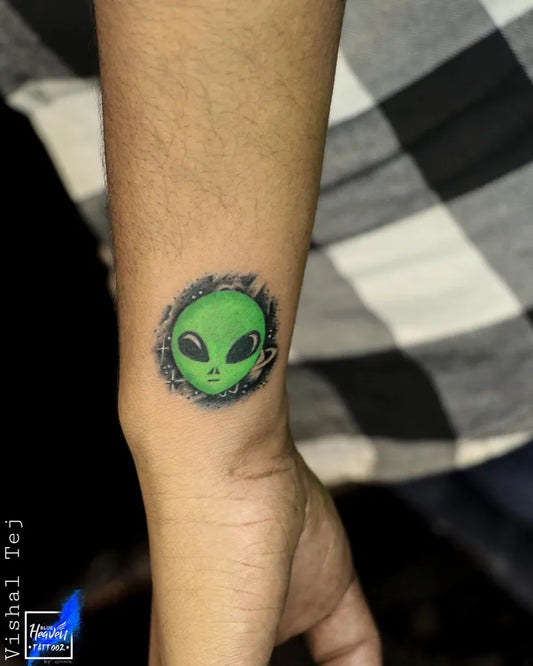 Small Dotwork Alien Head Tattoo on Men Wrist by @blue_heaven_tattooz