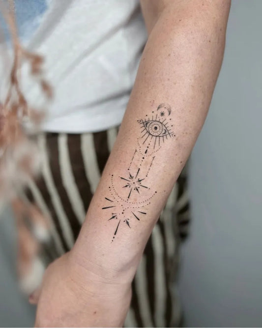 Small Dotwork Evil Eye Stars on Women Forearm Tattoo by @nothingwildtattoo